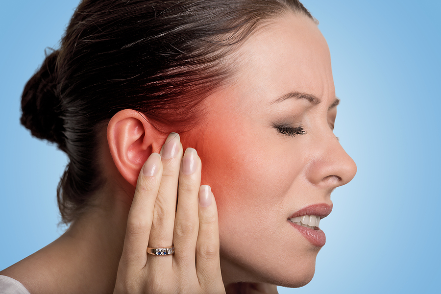 Tinnitus. Closeup up side profile sick female having ear pain